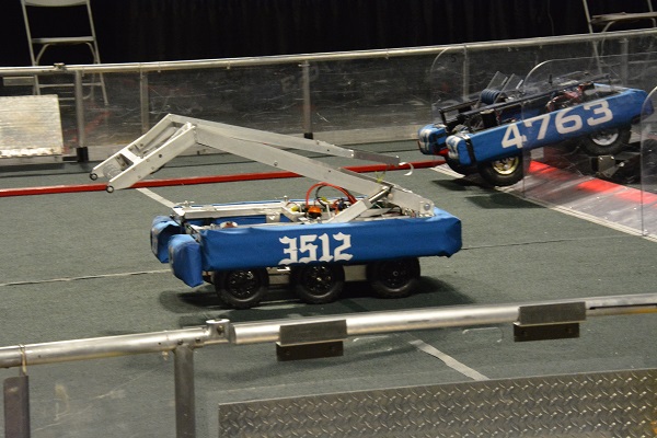 Robots breach a "moat" in 2016 FIRST Robotics Competition