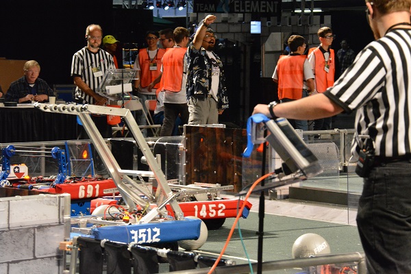 Students, referees and robots in the arena area