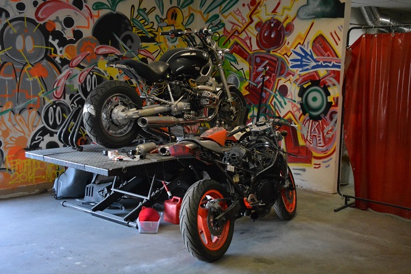 motorcycles near graffiti wall