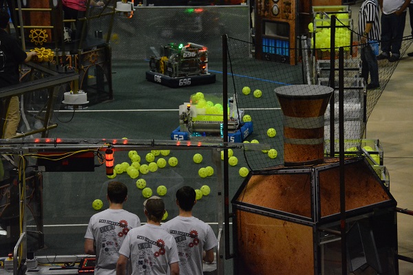 Robot fires balls at a target during FIRST® Robotics match