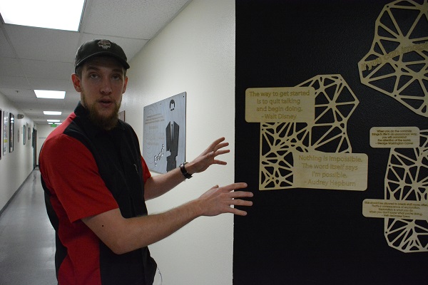 Vocademy General Manager Dylan Harter displays laser-cut plaques