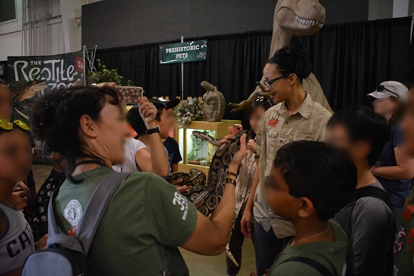 Scout troop leader and troop handle python at Imaginology