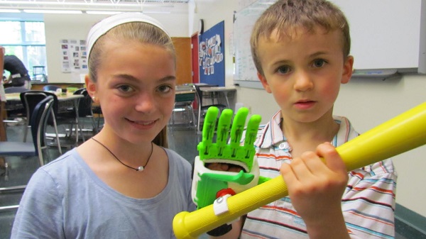 Max Lehrer with baseball grip device designed by student