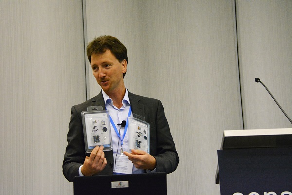 Eduardo Gallizio holds up Blue Coin robotic kits