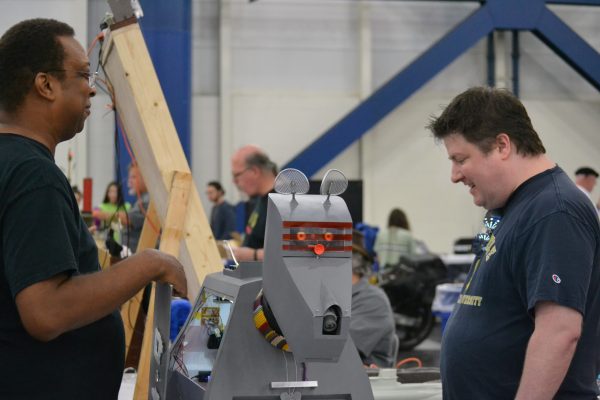 Man watches mahinery at work at Houston Maker Faire