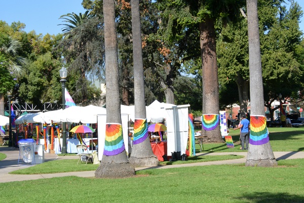 tree trunks with rainbow bunting and tents