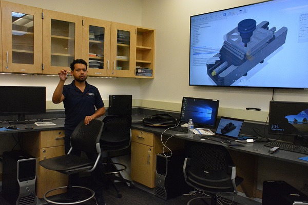 Curtis Chan displays a braided keychain inside Advanced Prototyping Center, during Maker Walk L.A.