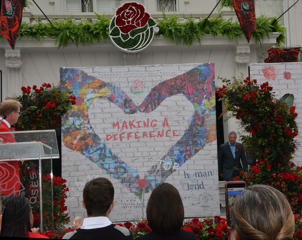 Gaery Sinise emerges from behind Tournament House banner