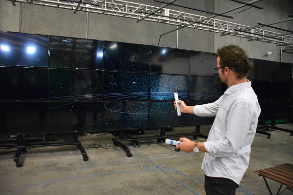 Pete Hawkes of Oblong Industries demonstrates the use of multiple computer screens during Maker Walk L.A.