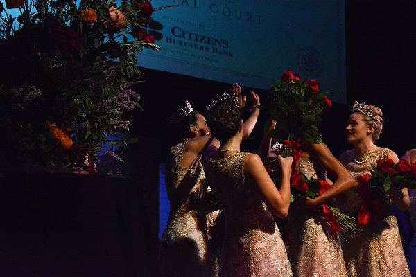 Royal Court members high-five at Rose Queen® coronation