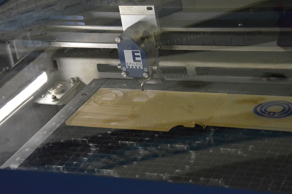 Massive lasercutter cutting a plastic ring during Maker Walk L.A.