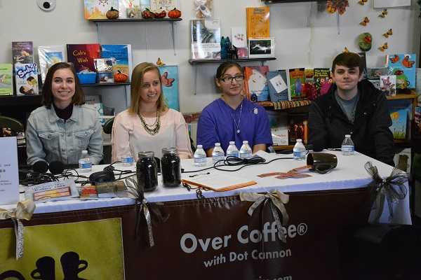 Hannah Shafiroff, Amanda Lechner, Ellie Liebermand and Conor Walsh behind a table with the banner for the show