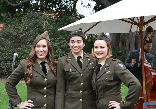 Three young women in 1940s military uniform outside Tournament House