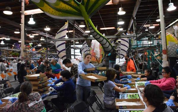 Volunteers carry boxes of dry materials to decorate