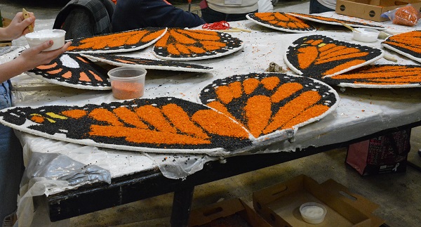 Volunteers paint butterflies closeup