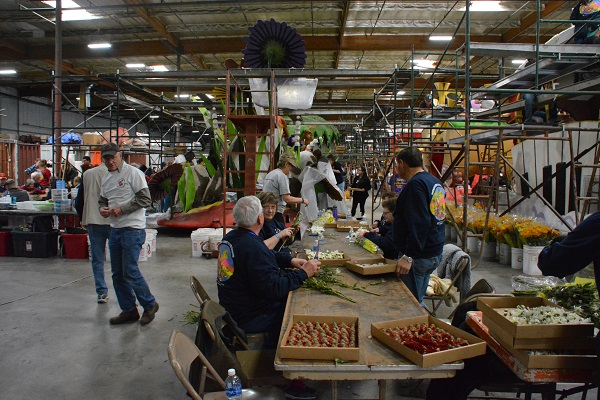 Volunteers at table gluing on dry materials