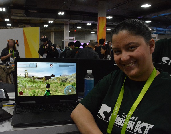 Amanda next to computer screen with dinosaur