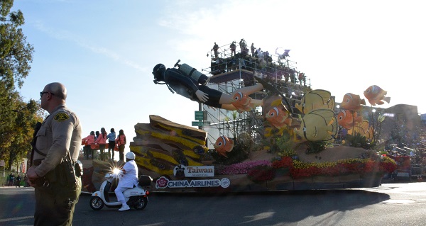 Caring for OUr Sea float with diver adn colorful fish goes by the reviewing stand