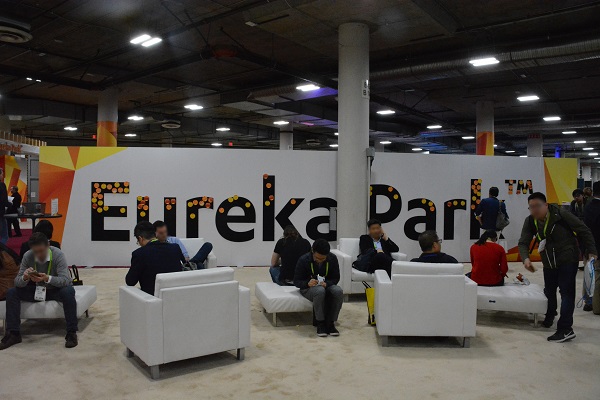 Eureka Park sign surrounded by CES 2018 attendees sitting in a lounge area