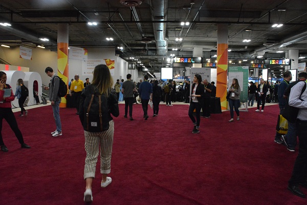 Attendees walk into Eureka Park marketplace near "Israel" sign at CES 2018