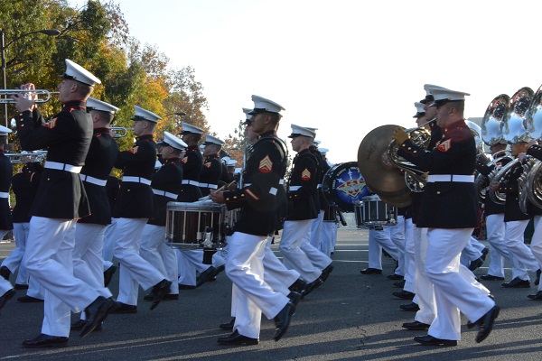 U.S. Marine Corps West Coast Composite Band marches past in dress blue uniforms, playing brass instruments