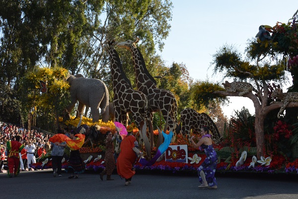 Costumed dancers perform near Dole float in 2018 Rose Parade