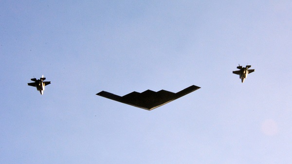 Spirit stealth bomber escorted by an F-35 on either side