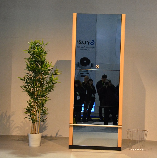 Laundroid unit with light-wood paneling and mirrored doors, stands on the show floor at CES 2018