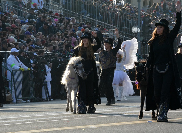 Three women n black steampunk outfits walk minihorses along Orange Grove Boulevard