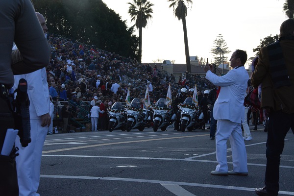 White Suiter photographs parade lineup and audience