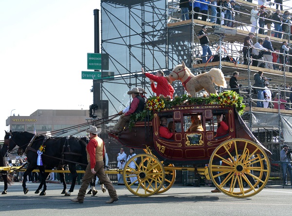 stuffed Palomino horse rides the back of a red Wells Fargo wagon at Colorado and Orange Grove Boulevards