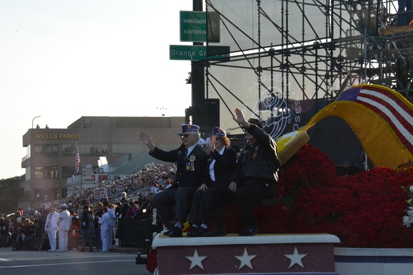 Three veterans wave from the float