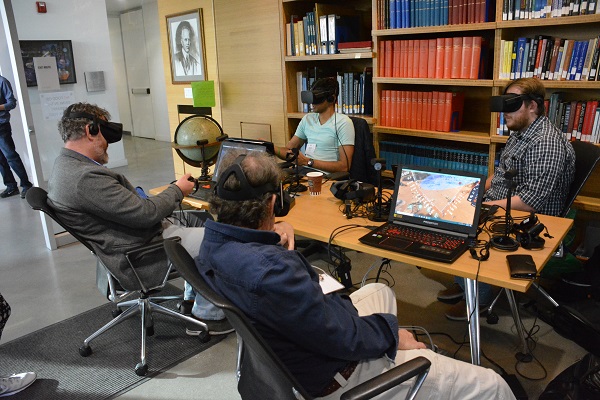 symposium participants wear headsets to check out virtual reality in Caltech library