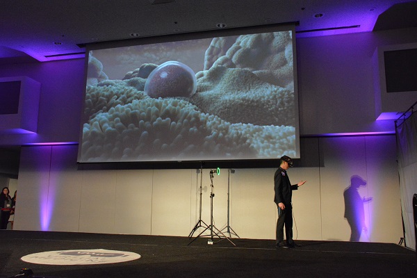 Dr. Spiegel in VR headset near slide of womb