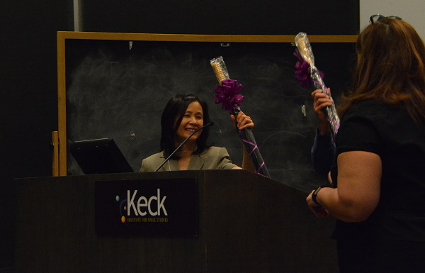 Emily Law recieves a gift-wrapped umbrella with a burgundy bow