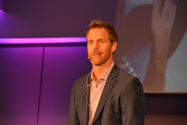 Mathew Stoudt onstage in front of a pink screen