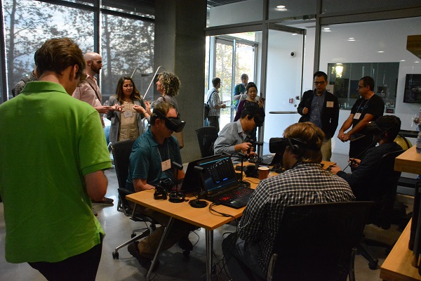 virtual reality symposium attendes try VR demos and wait in line in Caltech library