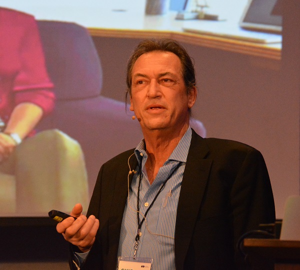 Dr. Skip Rizzon lectures from the podium during Day 2 of Cedars--------sinai's Medical Virtual Reality conference in Los Angeles