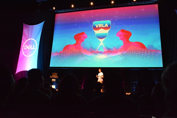 VRLA co-organizer oCosmo Scharf in front of VRLA slide onstage