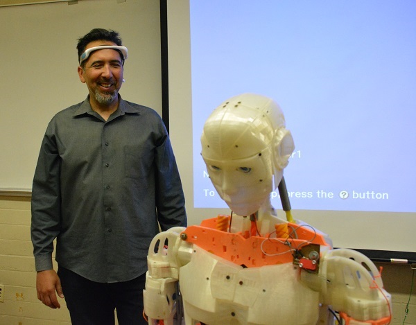 CSULB's Walter Martinez with Bluetooth device and Evo robot
