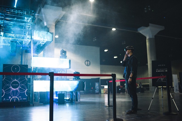 Mezo Creative Director and Executive Producer Christian Falstrup stands near his twenty-foot-tall laser-lit temple and wears a VR headset