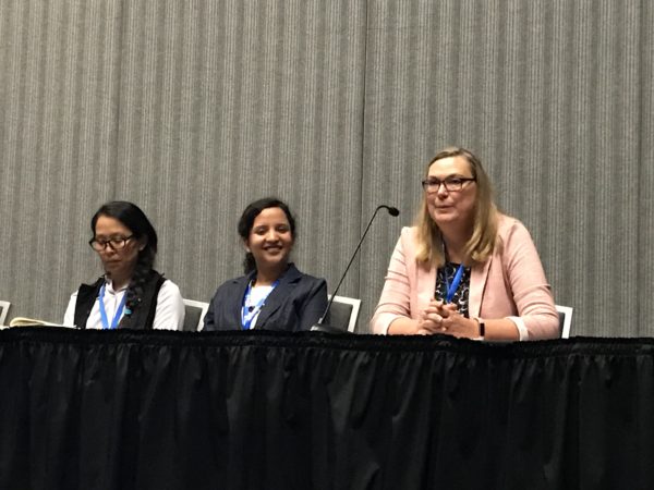 Melanie Daniels speaks on WISE panel as Pooja Agrawal and Julie Willey listen