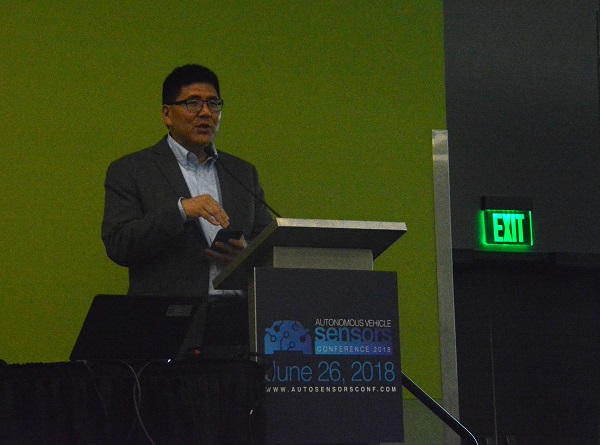 Will Tu closeup at Autonomous Vehicle Sensors Conference podium