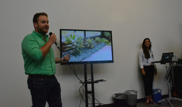 Alexander Joseph and Elif Kara show slide of four different-sized plants during "Demo Day"