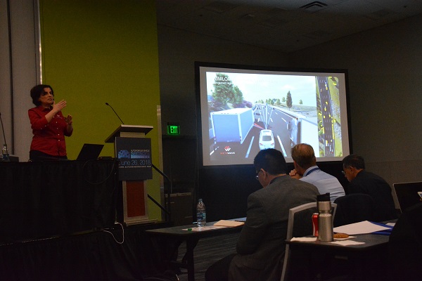 Autonomous Vehicles Conference attendees listen during Dr. Maha Acour's slide prenstation