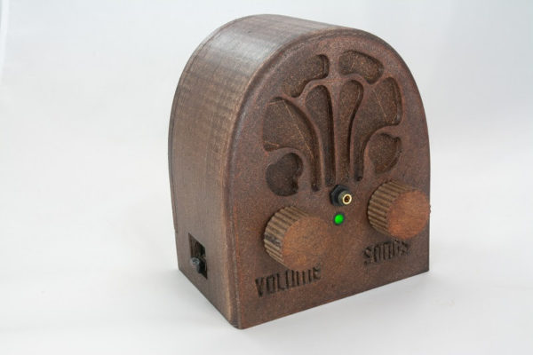 DQ Music Player in the style of a 1930s cathedral-style radio with two large knobs