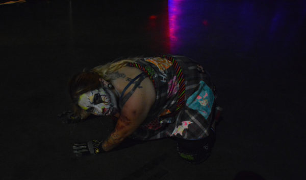 Zombie character crawls on floor in with red light reflection at ScareLA™ 2018