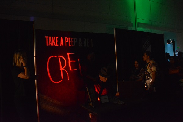 Visitors walk by red-lit haunt at ScareLA