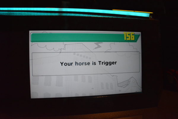 Closeup of computer screen, with "Your horse is Trigger" on it at Club 01