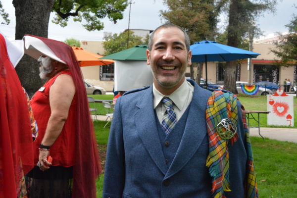 Aaron Saenz wears a blue jacket, tartan plaid kilt and a smile at SGV Pride 2018